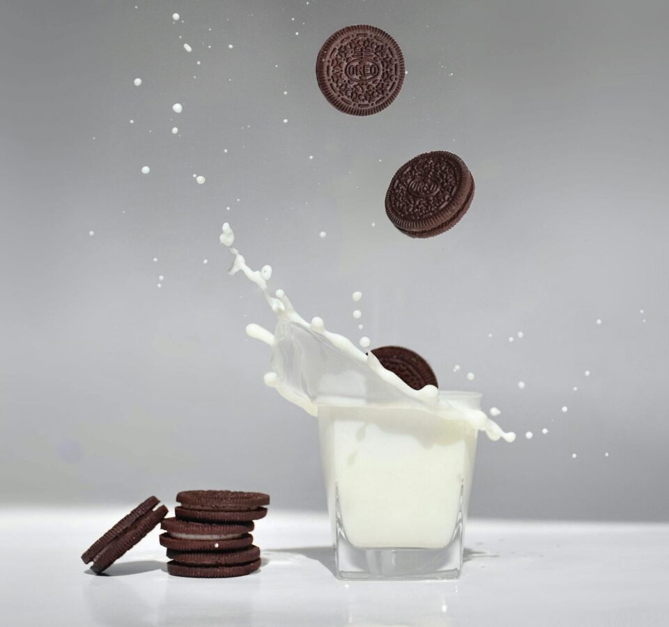 cookies falling into a glass of milk